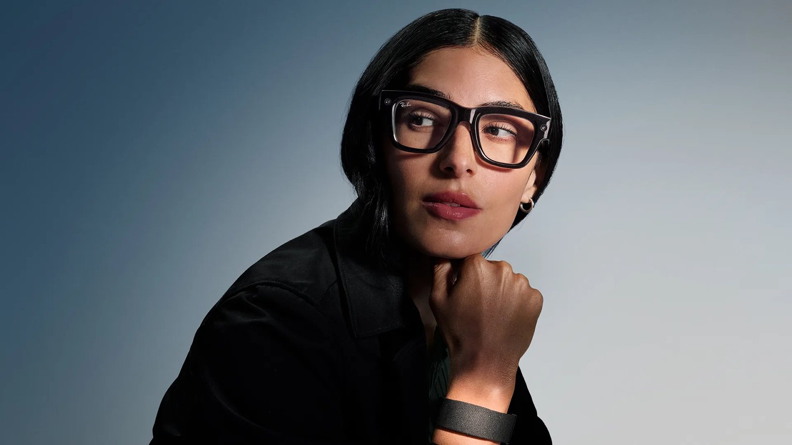 A woman wearing Meta Ray-Ban Display glasses with the Meta Neural Band on her wrist