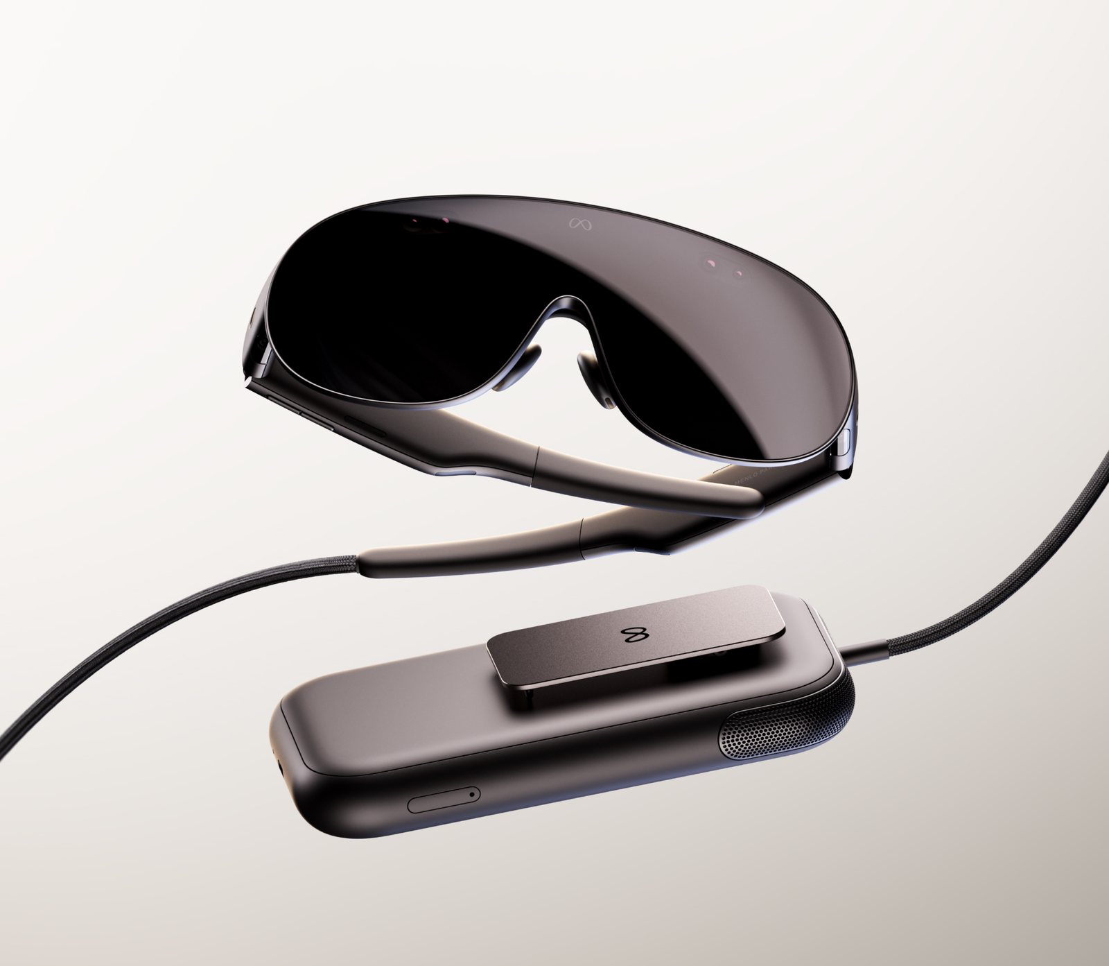 Meta VR Glasses and their clip-on compute puck, connected by a braided cable